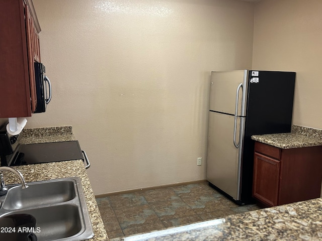 kitchen with stainless steel refrigerator and sink