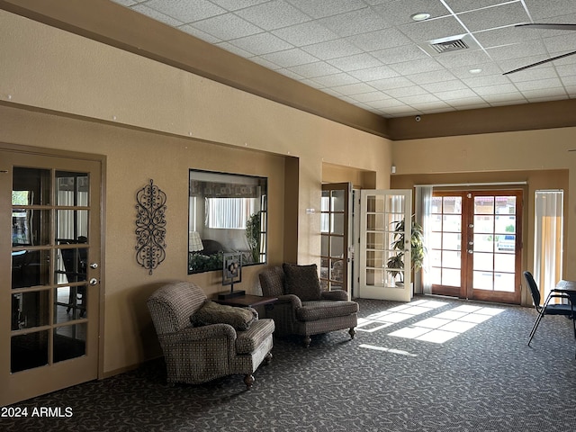 interior space with french doors and a paneled ceiling