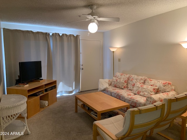 living room featuring a textured ceiling, carpet flooring, and ceiling fan