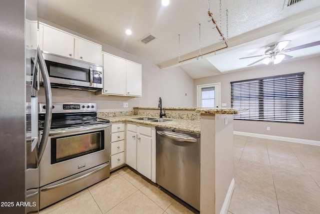 2301 E University Dr Unit 210, Mesa, AZ 85213 - kitchen featuring stainless steel appliances, a peninsula, light tile patterned floors, light stone counters, and recessed lighting