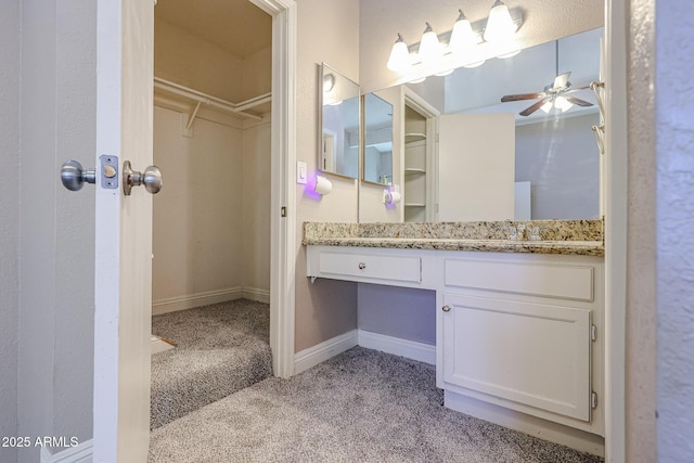 2301 E University Dr Unit 210, Mesa, AZ 85213 - bathroom featuring a ceiling fan, vanity, a walk in closet, and carpet
