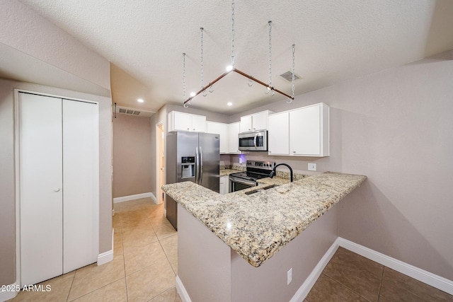 2301 E University Dr Unit 210, Mesa, AZ 85213 - kitchen with appliances with stainless steel finishes, light stone countertops, a peninsula, light tile patterned floors, and a textured ceiling
