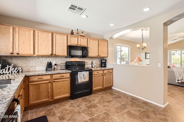 kitchen with light brown cabinets, visible vents, decorative backsplash, arched walkways, and black appliances
