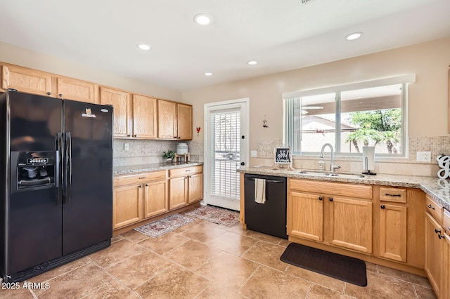 kitchen featuring light brown cabinets, recessed lighting, a sink, decorative backsplash, and black appliances