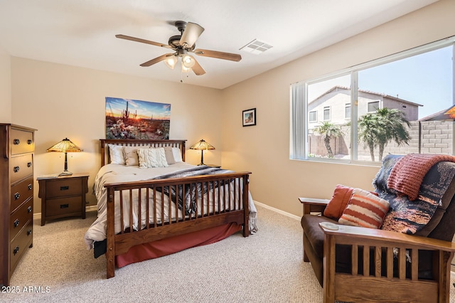 bedroom featuring light colored carpet, baseboards, a ceiling fan, and visible vents
