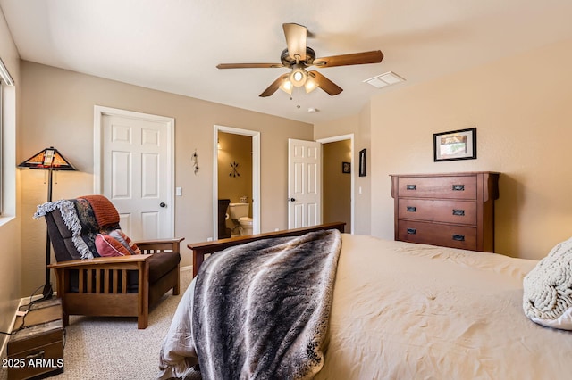 bedroom featuring carpet, ensuite bathroom, visible vents, and ceiling fan
