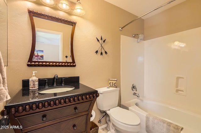 bathroom with toilet, vanity, and shower / washtub combination