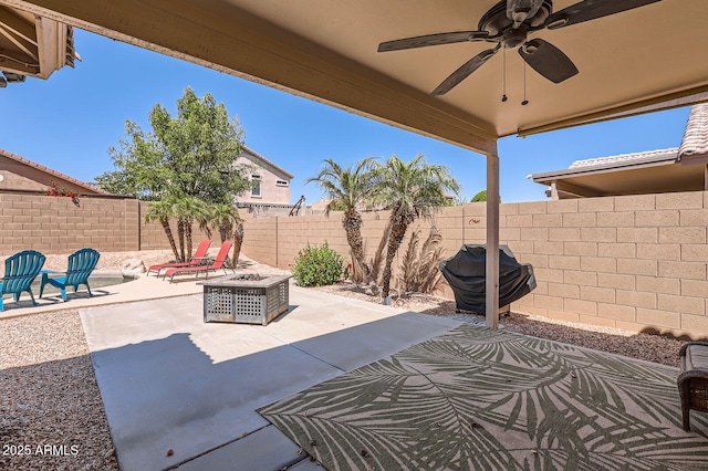view of patio with a fenced backyard, ceiling fan, an outdoor fire pit, and a grill