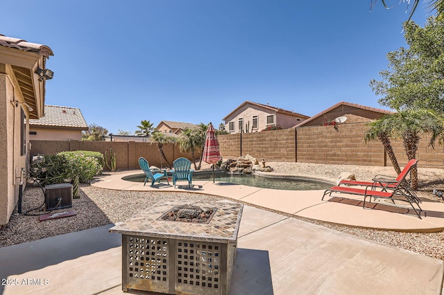 view of patio with a fire pit, a fenced in pool, and a fenced backyard