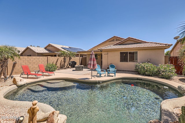 view of swimming pool with a patio area, a fenced in pool, and a fenced backyard