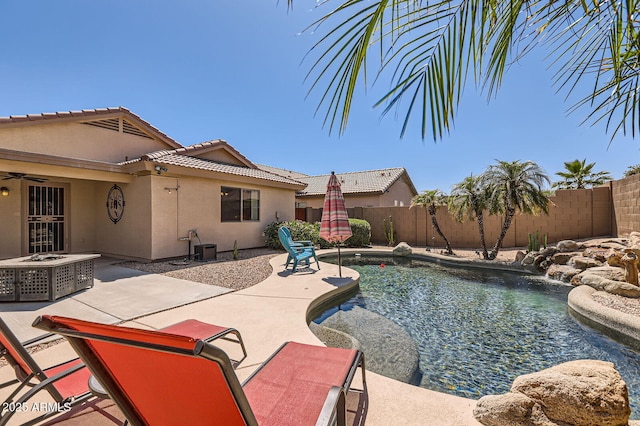 view of swimming pool featuring a ceiling fan, a patio area, a fenced in pool, and a fenced backyard