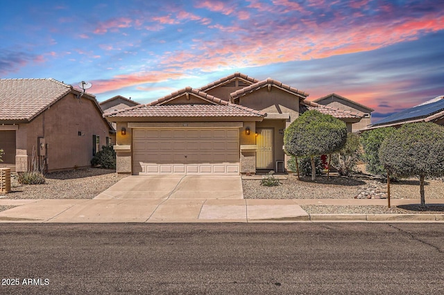 single story home featuring a tile roof, a garage, stucco siding, and driveway