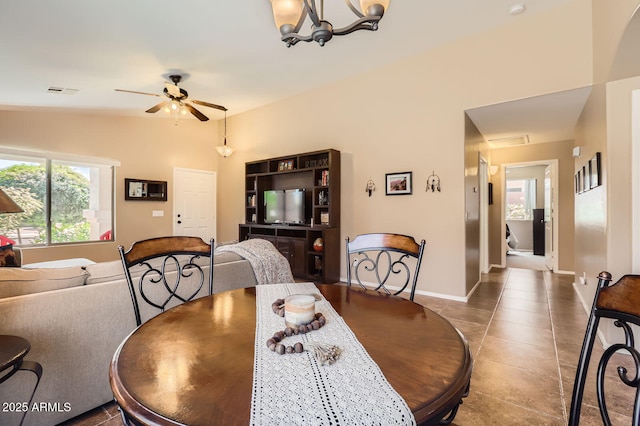 dining space featuring tile patterned floors, visible vents, baseboards, and ceiling fan