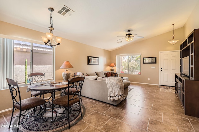 dining space with lofted ceiling, ceiling fan with notable chandelier, baseboards, and visible vents