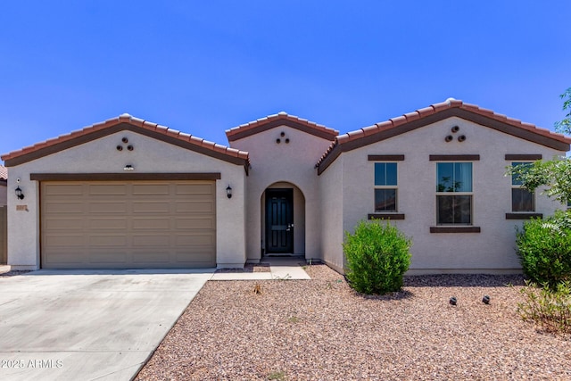 2347 W Sunland Ave, Phoenix, AZ 85041 - mediterranean / spanish home with concrete driveway, a tiled roof, stucco siding, and a garage