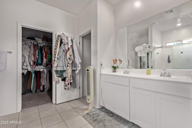 2347 W Sunland Ave, Phoenix, AZ 85041 - full bath featuring tile patterned flooring, a walk in closet, double vanity, and a shower