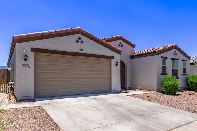 2347 W Sunland Ave, Phoenix, AZ 85041 - mediterranean / spanish-style home featuring stucco siding, a tile roof, concrete driveway, and an attached garage