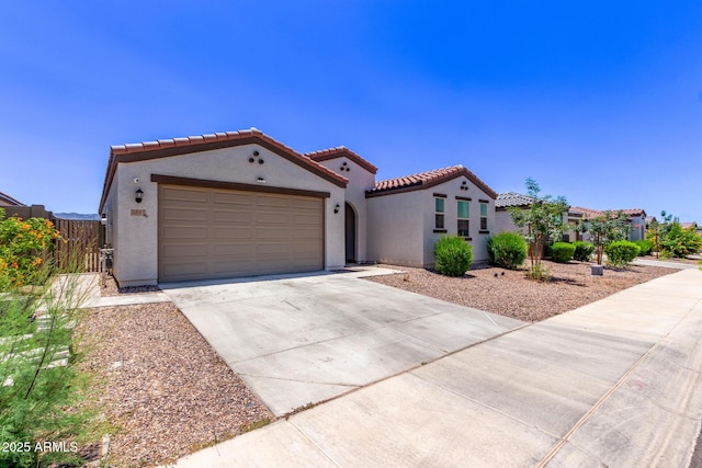 2347 W Sunland Ave, Phoenix, AZ 85041 - mediterranean / spanish-style house with stucco siding, a tiled roof, driveway, and an attached garage