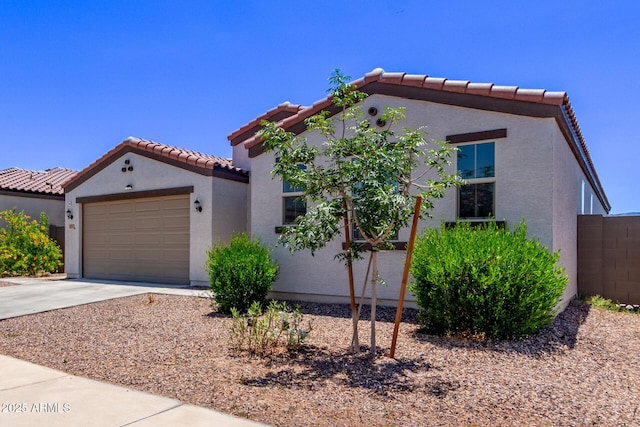 2347 W Sunland Ave, Phoenix, AZ 85041 - mediterranean / spanish-style home with a tiled roof, driveway, stucco siding, and an attached garage