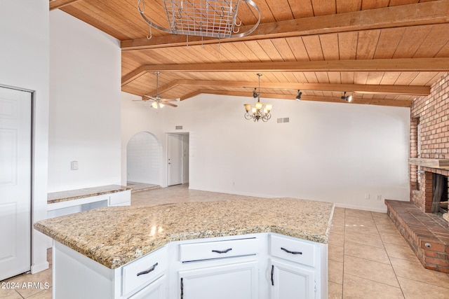 kitchen featuring a brick fireplace, decorative light fixtures, white cabinetry, wooden ceiling, and ceiling fan with notable chandelier