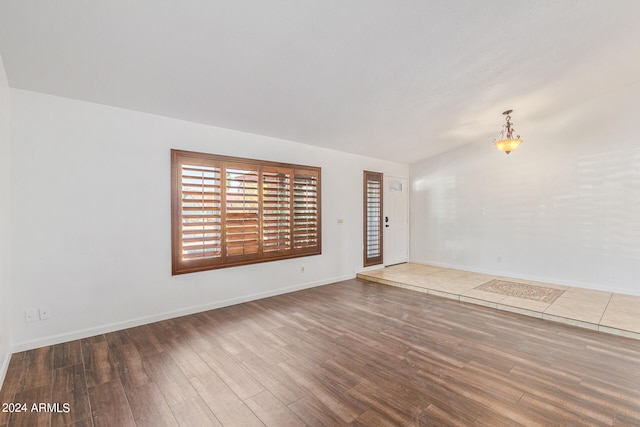 unfurnished room featuring dark hardwood / wood-style flooring