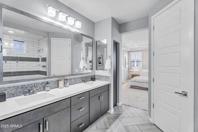 ensuite bathroom with double vanity, a sink, and ensuite bathroom