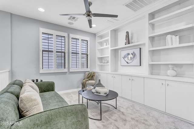 living area featuring light carpet, baseboards, visible vents, and built in features