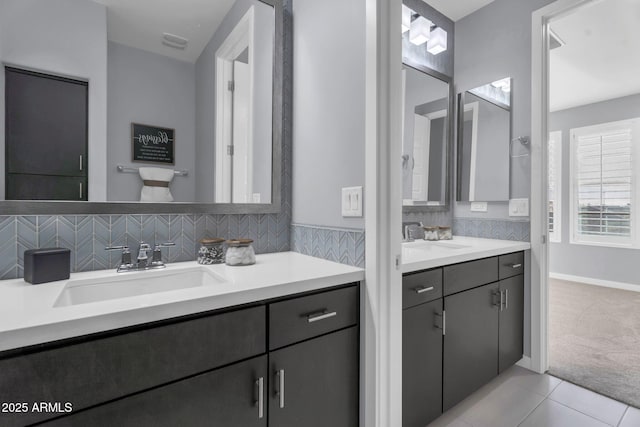 full bathroom featuring decorative backsplash, two vanities, a sink, and tile patterned floors