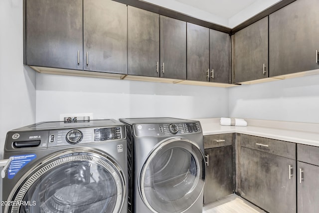 laundry area with washing machine and dryer and cabinet space