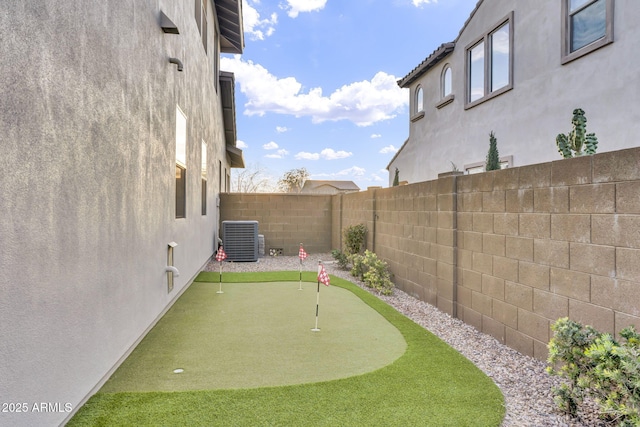 view of yard with cooling unit and a fenced backyard