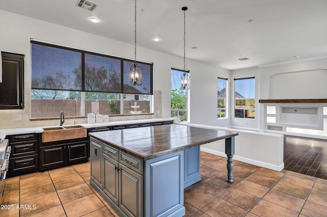 10310 N 135th Way, Scottsdale, AZ 85259 - kitchen with light tile patterned floors, healthy amount of natural light, a kitchen island, pendant lighting, and recessed lighting