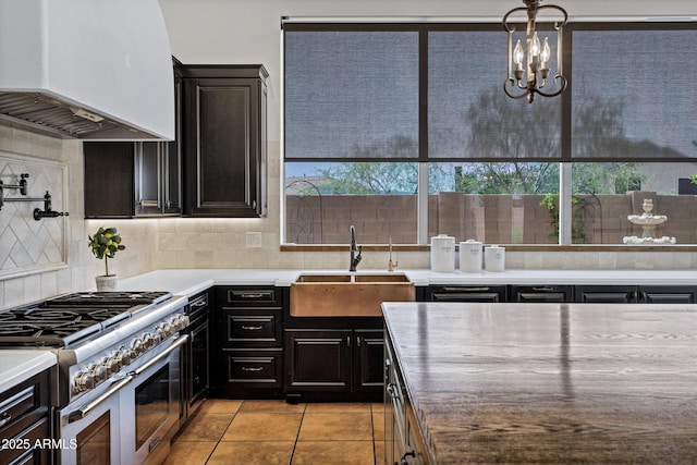 10310 N 135th Way, Scottsdale, AZ 85259 - kitchen featuring custom range hood, range with two ovens, tasteful backsplash, light tile patterned floors, and dark cabinets