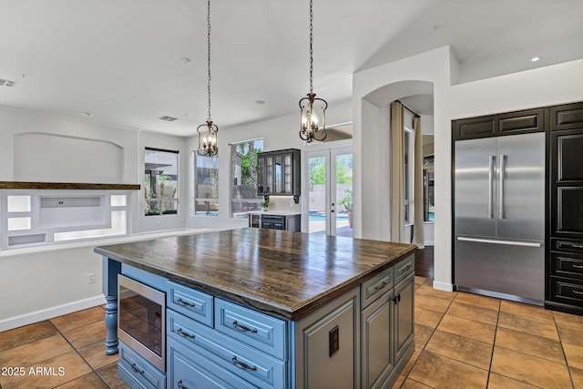 10310 N 135th Way, Scottsdale, AZ 85259 - kitchen with built in appliances, tile patterned flooring, a chandelier, and arched walkways