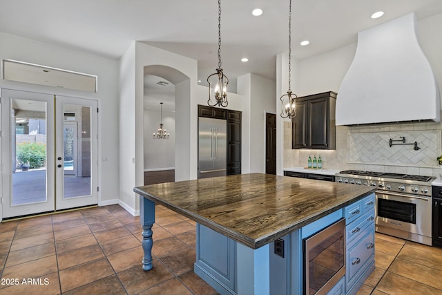 10310 N 135th Way, Scottsdale, AZ 85259 - kitchen with built in appliances, premium range hood, tasteful backsplash, a center island, and recessed lighting