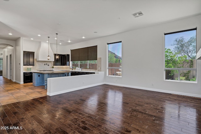 10310 N 135th Way, Scottsdale, AZ 85259 - kitchen with tasteful backsplash, hardwood / wood-style floors, custom exhaust hood, recessed lighting, and arched walkways