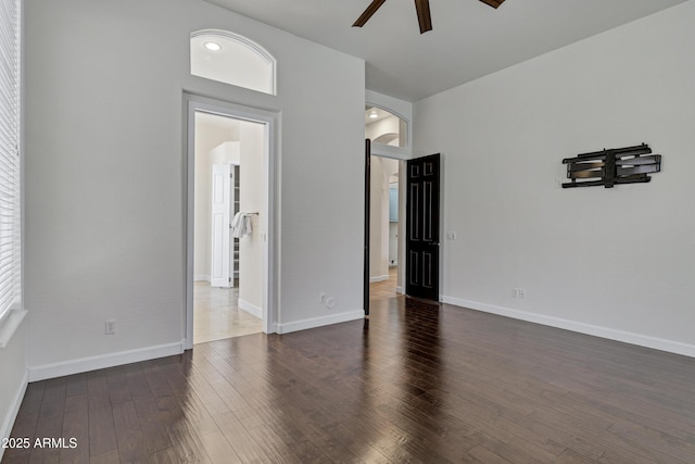 10310 N 135th Way, Scottsdale, AZ 85259 - spare room with arched walkways, a ceiling fan, and dark wood-style flooring