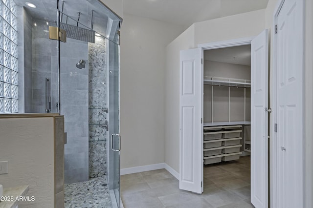 10310 N 135th Way, Scottsdale, AZ 85259 - bathroom with a stall shower, a walk in closet, and tile patterned flooring