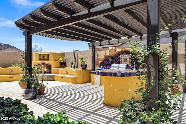 10310 N 135th Way, Scottsdale, AZ 85259 - view of patio / terrace featuring a warm lit fireplace, exterior kitchen, and a pergola