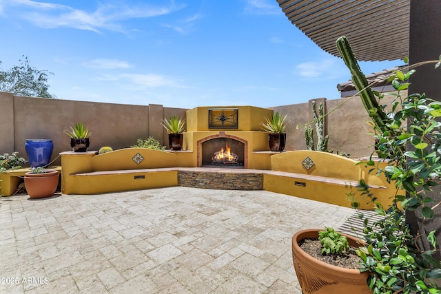 10310 N 135th Way, Scottsdale, AZ 85259 - view of patio / terrace featuring a lit fireplace