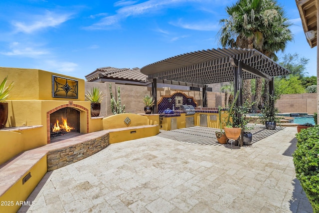 10310 N 135th Way, Scottsdale, AZ 85259 - fenced backyard with a warm lit fireplace, exterior kitchen, and a patio area