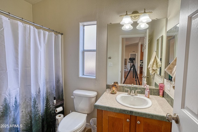 bathroom with toilet, vanity, and curtained shower