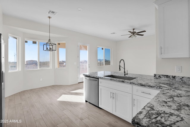 kitchen featuring white cabinetry, dishwasher, light stone countertops, and sink