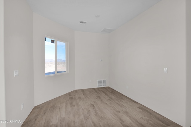 spare room with light wood-type flooring