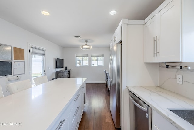4402 E Montecito Ave, Phoenix, AZ 85018 - kitchen featuring appliances with stainless steel finishes, white cabinetry, dark wood finished floors, recessed lighting, and light stone countertops
