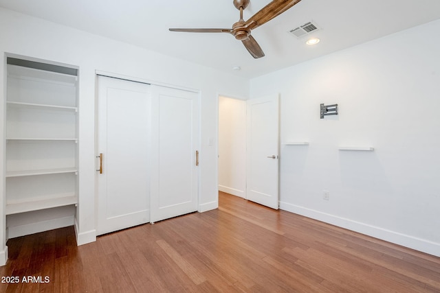4402 E Montecito Ave, Phoenix, AZ 85018 - unfurnished bedroom with wood finished floors, baseboards, multiple closets, ceiling fan, and recessed lighting
