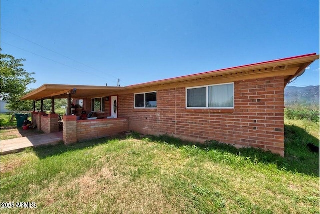 rear view of house featuring brick siding