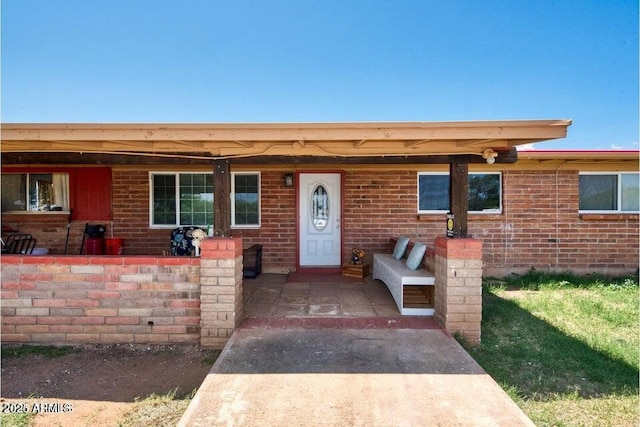 view of front of house featuring a porch and brick siding