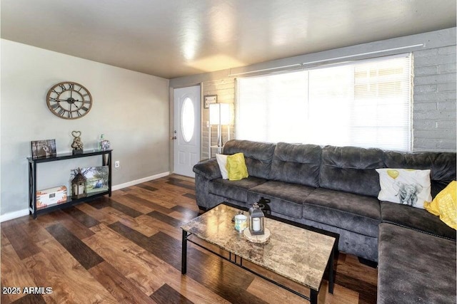 living area with baseboards and wood finished floors