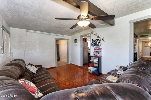 living area featuring a textured ceiling, visible vents, and a ceiling fan