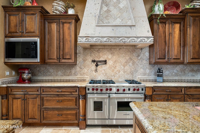 11457 E Salero Dr, Scottsdale, AZ 85262 - kitchen with tasteful backsplash, black microwave, range with two ovens, and extractor fan
